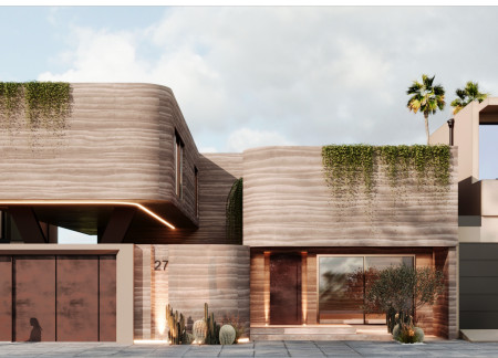 Rammed Earth Structure Embraces Desert Context with Corten Steel Accents and Community Courtyards