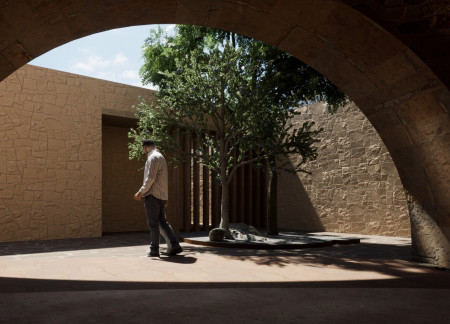 Stone Cladding and Arched Design in a Community-Focused Cultural Hub