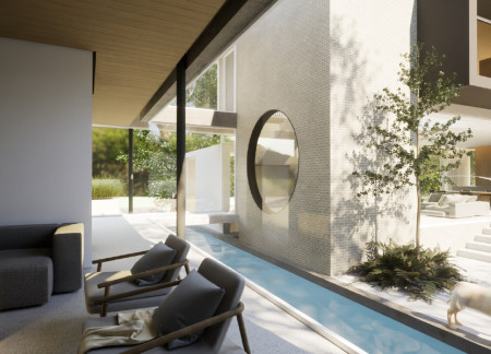 Circular Apertures and Natural Light Enhancements in a Concrete and Glass Residence