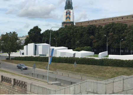 Sculptural White Stone Facades Integrated with Natural Brown Elements for Community Remembrance