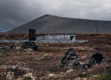 Charred Wooden Shingles and Concrete Formations in a Volcanic Landscape Community Hub