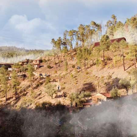Elevated Red Timber Structure Enhances Connection with Nature Through Modular Design