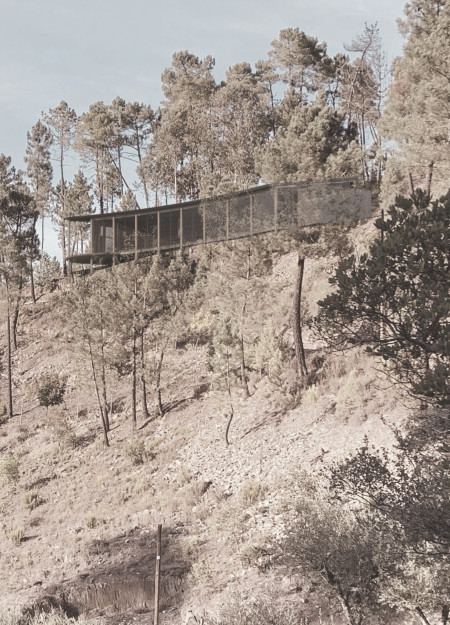 Reflective Glass and Slate Yoga Retreat Integrated into a Cliffside Landscape
