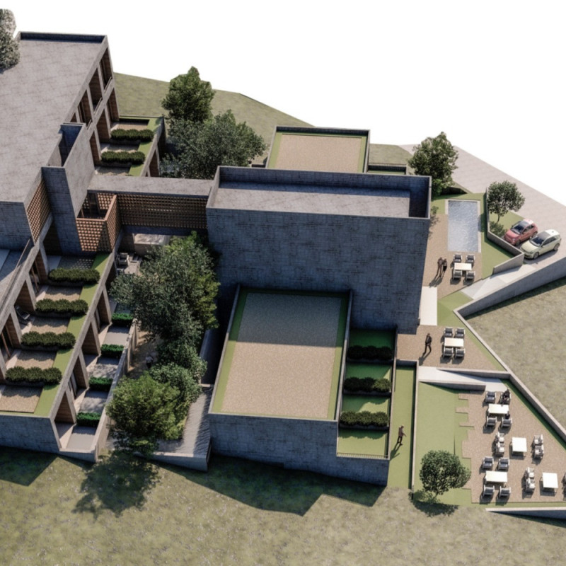 Chapel at the Core of Communal Living Enhanced by Natural Stone and Terraced Green Roofs