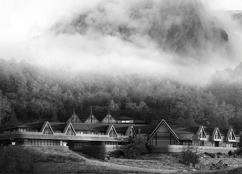 Sustainable Getaway Featuring Local Stone and Sloped Roof Emphasizing Mountain Views