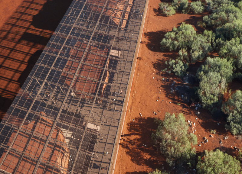 Sculptural Roof Design Crafted with Weathered Steel and Encased in Glass for a Versatile Community Hub