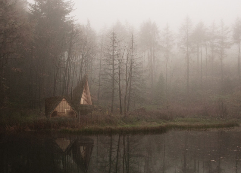 Elevated Meditation Cabin with Rough Walls and Communal Fireplace