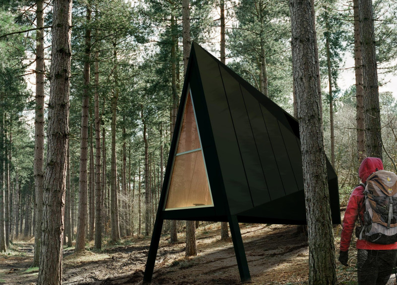 Black-Clad Meditation Cabin with Lofted Sleeping Space and Wooden Interiors