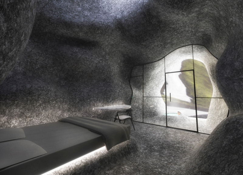 Local Stone and Glass Fiber Panels Create Camouflaged Community Gathering Space